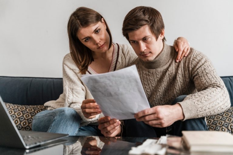 close up couple reading document 768x512